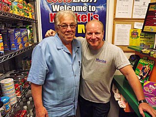 Coaster Photo - George Krenkel (left), owner of Krenkel’s convenience store in Neptune, is pictured with comedian Mike Marino at the store.