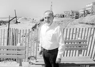 Coaster Photo: J.P. Gradone, chief operating officer for the Ocean Grove Camp Meeting Association, stands in front of the boardwalk replacement project now under way in the historic district.