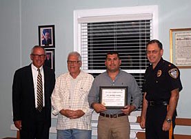 Allenhurst Police Officer Michael DiBona received an award recently for his work in searching for and applying for the procurement of equipment for the borough. He is pictured with Mayor David McLaughlin, DiBona’s father, Sal, and Police Chief Robert Richter (right).