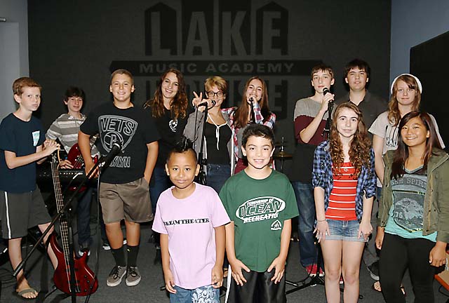 Liz Fackelman, an instructor at the Lake House Music Academy in Asbury Park, is pictured with her students during a rehearsal break.