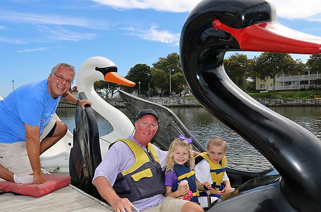 Neil Zarpella helps Bill Looney of Avon with Ava and Jake at the pedal boat rides on Wesley Lake in Asbury Park. The business will operate on the weekends until the end of October.