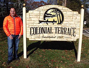 Coaster Photo - Colonial Terrace Protective Association member Jon Girrson stands next to a new sign marking the entrance, off Wickapecko Drive, to the small neighborhood in Ocean Township.