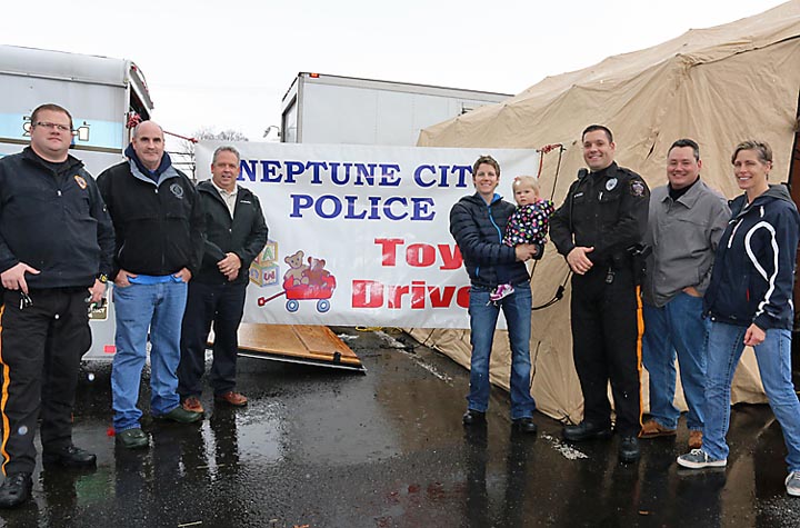 Neptune City police collected for the Toys for Tots program recently at the Neptune City Shopping Center. Pictured were Police Officers Mark Mazzeo (left) and Janell Pyzik (right) with Navy and Andrew and Aly Reynolds, all of Neptune.