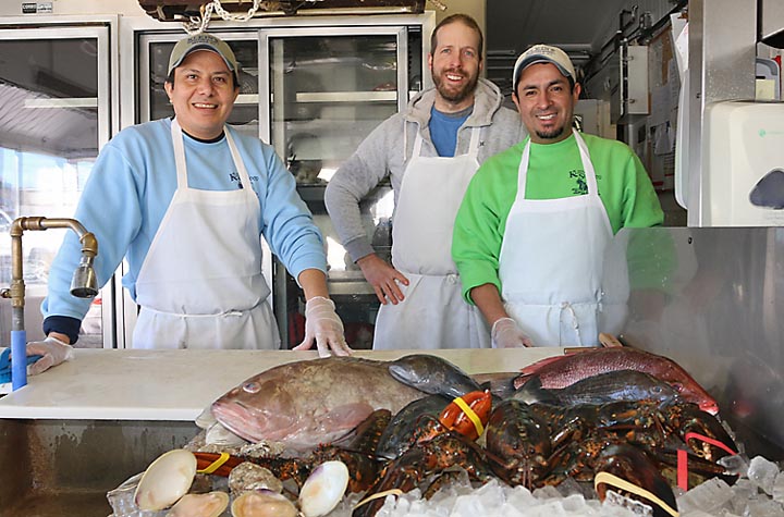 Ready to serve their fresh-caught fish at Klein’s Fish Market were Leo Flores, Tod Vitalis and Carlos Alvarez.