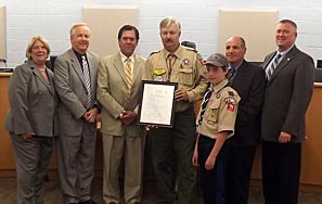 Coaster Photo - Ocean Township resident Don Brockel was recognized by the Township Council last week for his 50 years of service to the Boy Scouts of America. The council and Troop 71 Second Class Scout Orin Fisch presented Brockel (center) with the award.