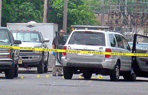 Evidence markers dot the scene around the silver sport utility vehicle of Neptune Police Sgt. Phillip Seidle on Sewall Avenue at Ridge Avenue in Asbury Park June 17. He is charged with murdering his ex-wife, Tamara Seidle.