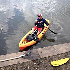 Mayor Gary Engelstad paddled his kayak picking up debris at the Sylvan Lake clean up Sun., May 31.