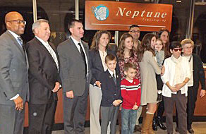 Coaster Photo - Recently-promoted Neptune Police Captain Anthony Gualario (third from left) is joined by friends, family and township officials during his swearing-in ceremony at this week’s Township Committee meeting.