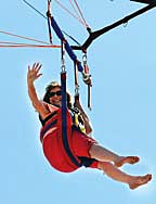 Coaster Photos - Neptune Midtown Community Elementary School Principal Arlene Rogo waved to students from her parasail over the Ocean Grove beach Monday morning.