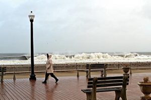 Coaster Photo by Mike Kearns - During the storm Tuesday a pedestrian walked the boardwalk in Ocean Grove.