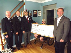 Coaster Photo - Monmouth County Fire Marshall Kevin Stout, Jersey Shore Dream Center Founder Isaac Friedel, VFW Post 1333 Frank Brogna and Monmouth County Sheriff Shaun Golden present Marine veteran Scott Nokes with a $5,000 check on Monday.