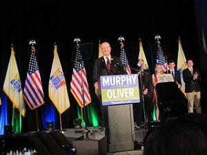 Coaster Photo - Phil Murphy with his family behind him addressed an enthusiastic crowd in the Grand Arcade in Asbury Park’s Convention Hall Tuesday night.
